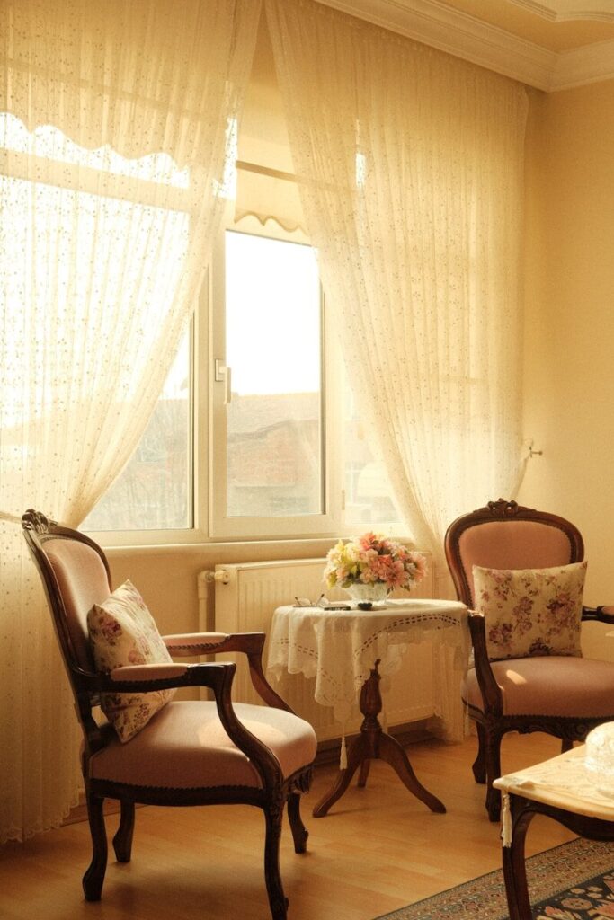 A living room with two chairs and a table
